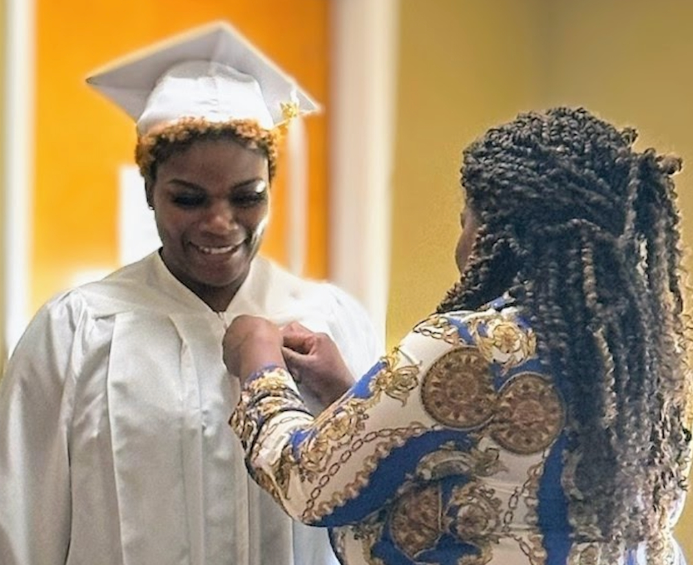 Tyanna being pinned at graduation by her mom.